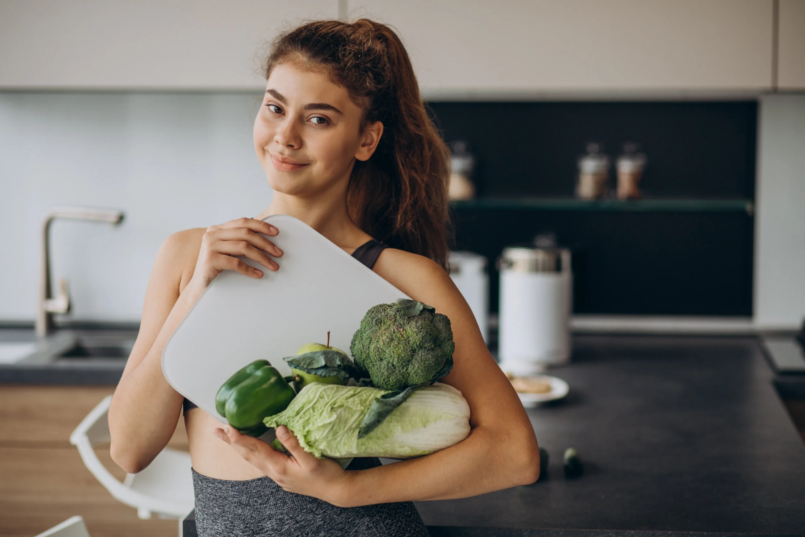 young-sporty-woman-with-scales-vegetables-kitchen